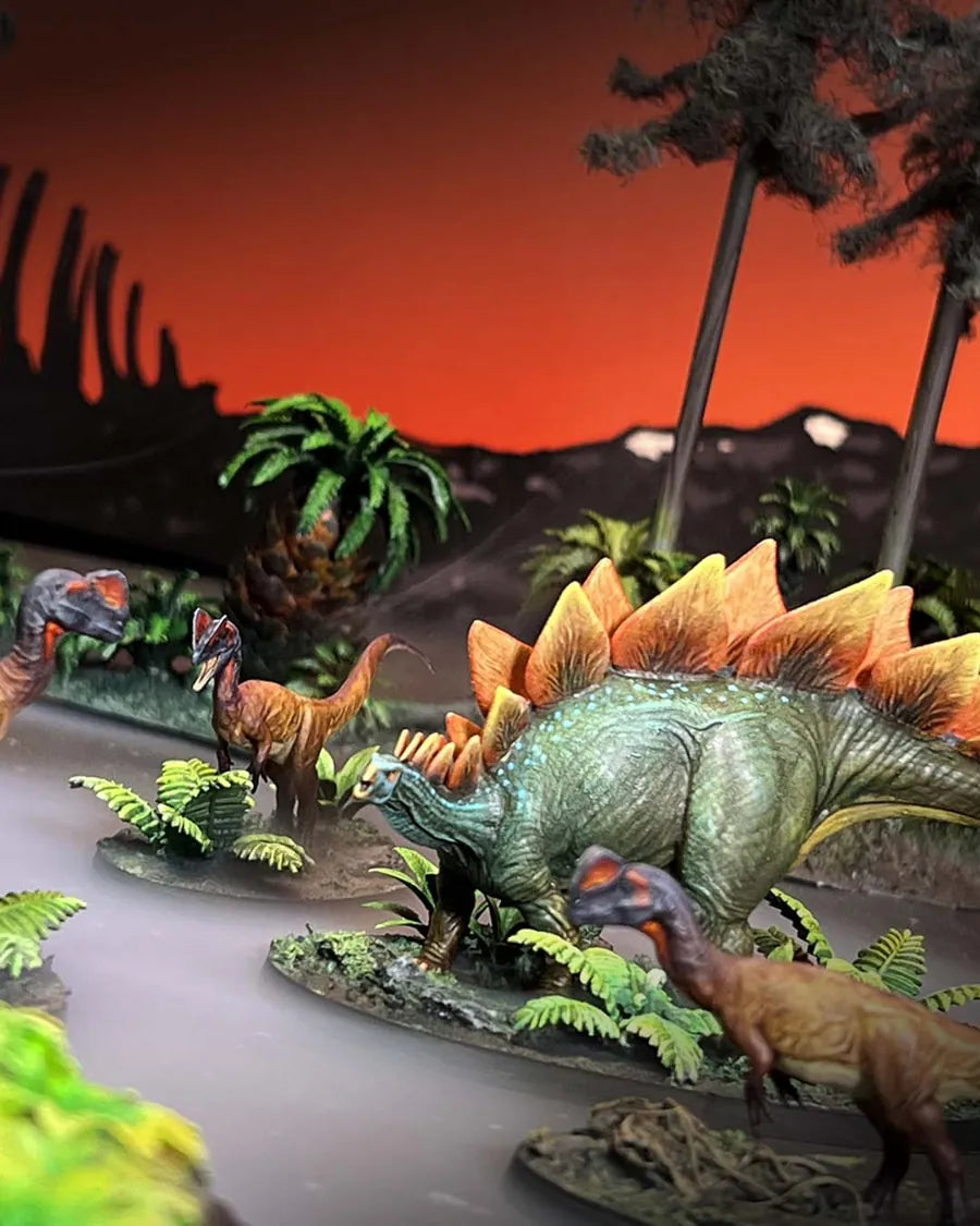 Painted Stegosaurus with raptors on a jungle table